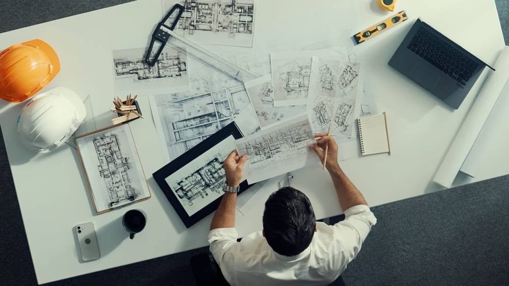 Top view of engineer looking at various site plans