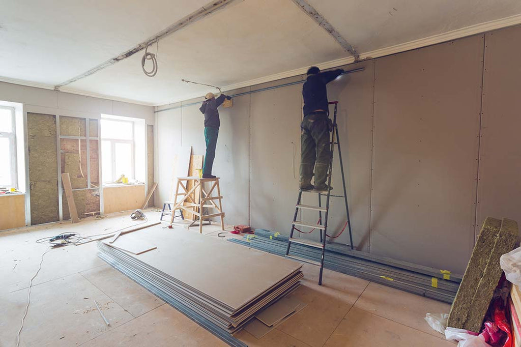 Contractors installing plasterboard for a home remodeling project
